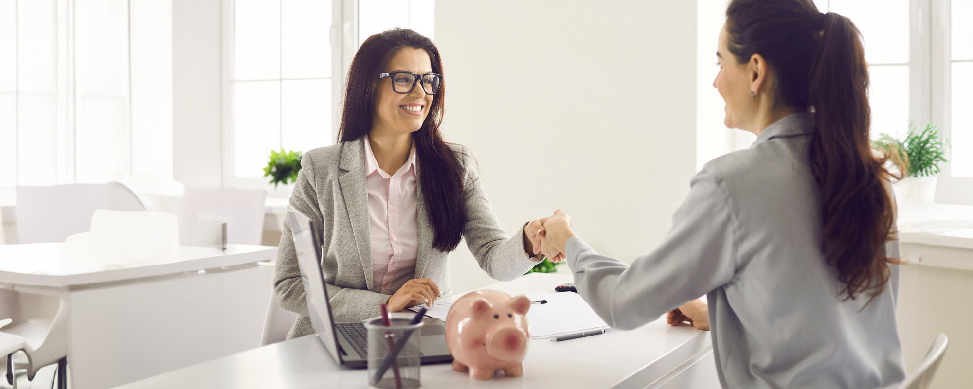 female bank manager shakes hands with a client