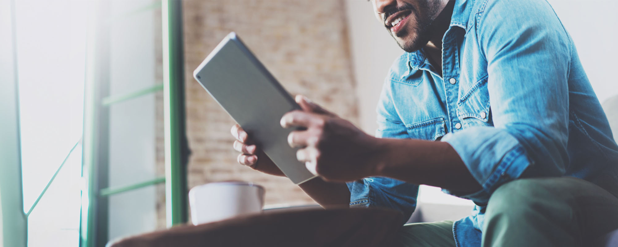 man reading on tablet