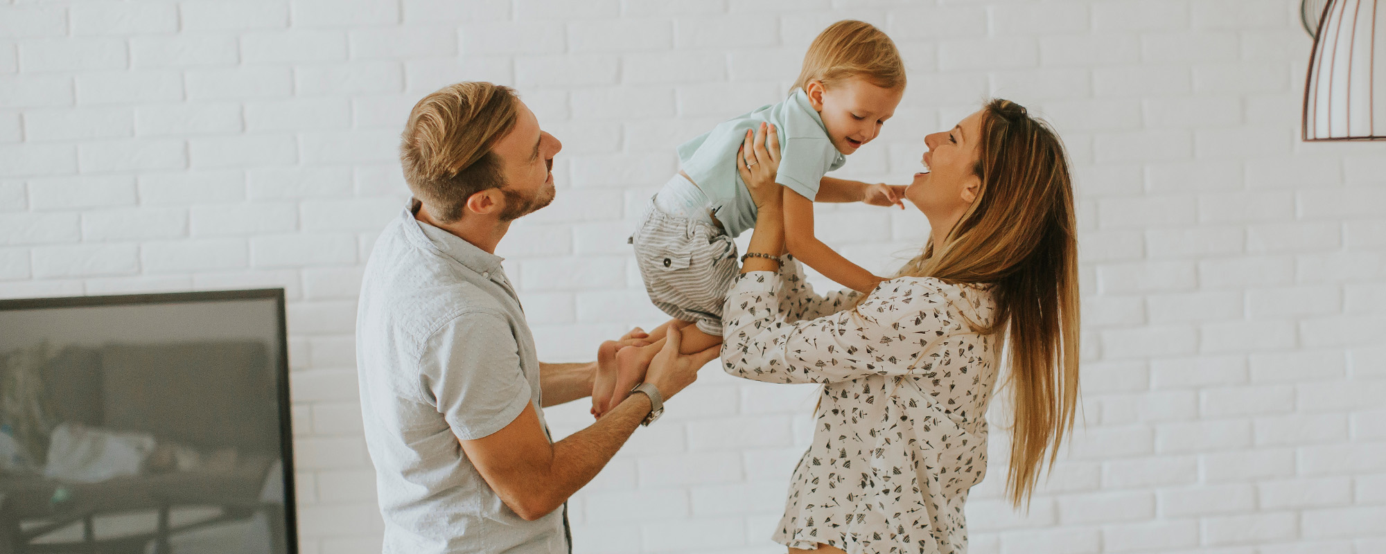 young happy family hugging in the room