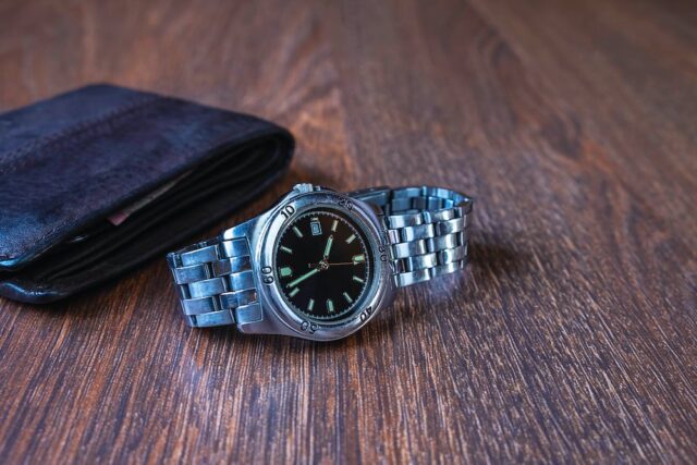 watch and wallet on a table