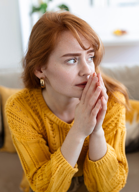 sad woman feels miserable desperate sit on sofa