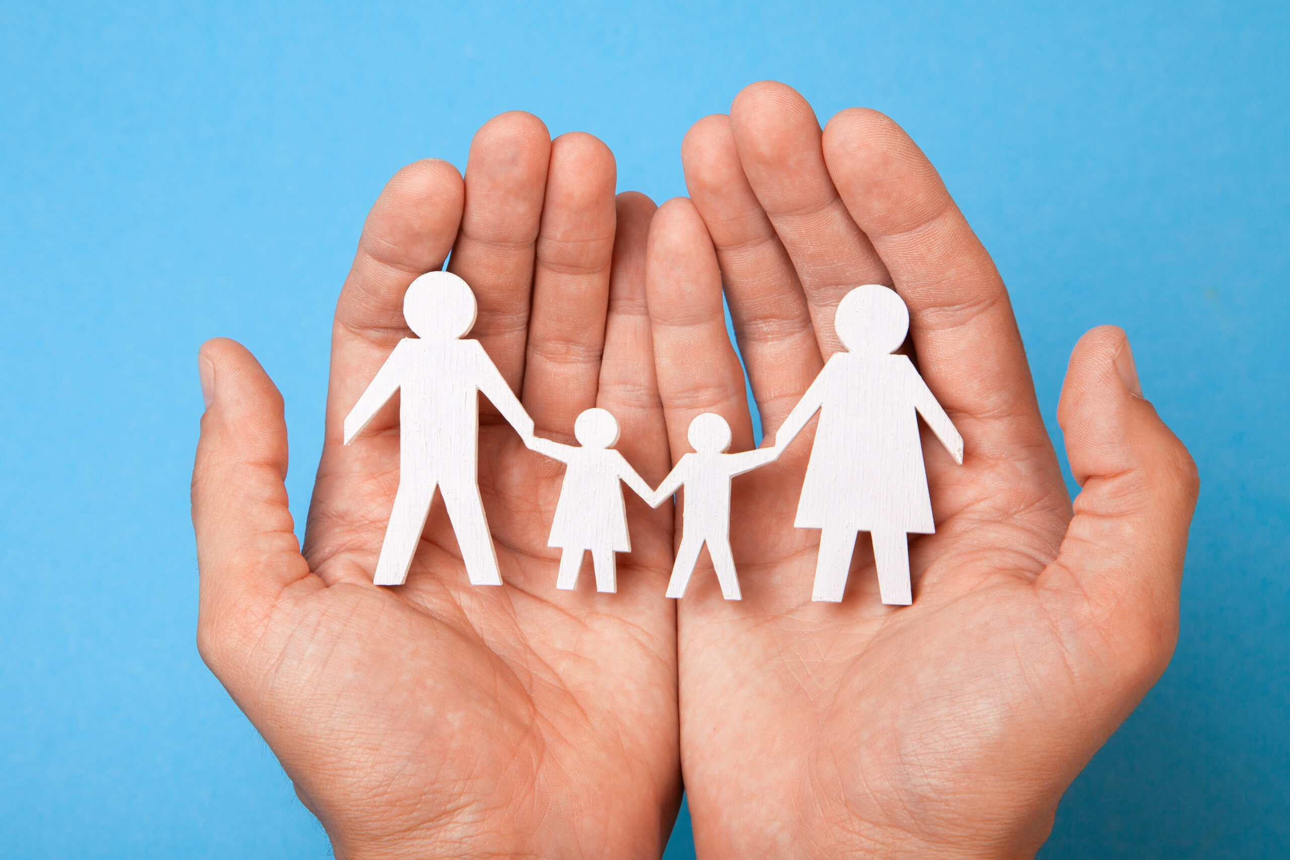 paper family cut out in hands