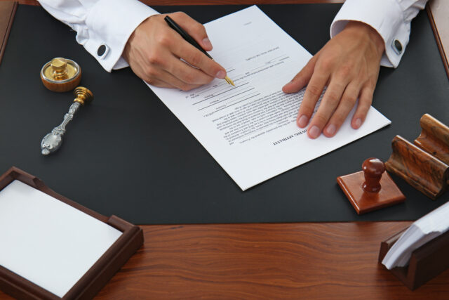 Notary public signing document in office