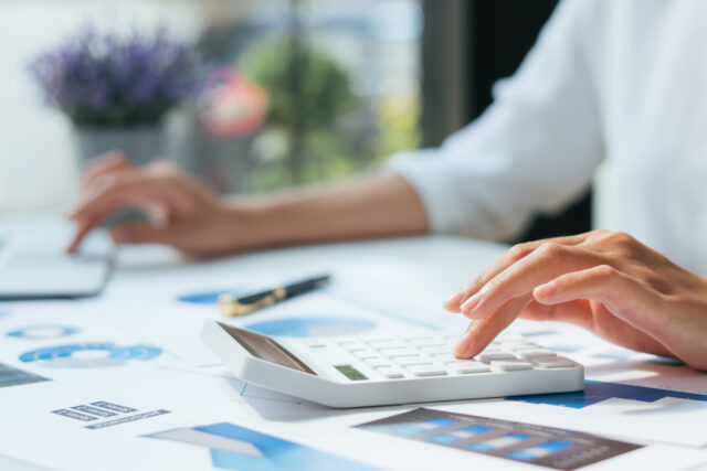 Business accounting concept, Business man using calculator with