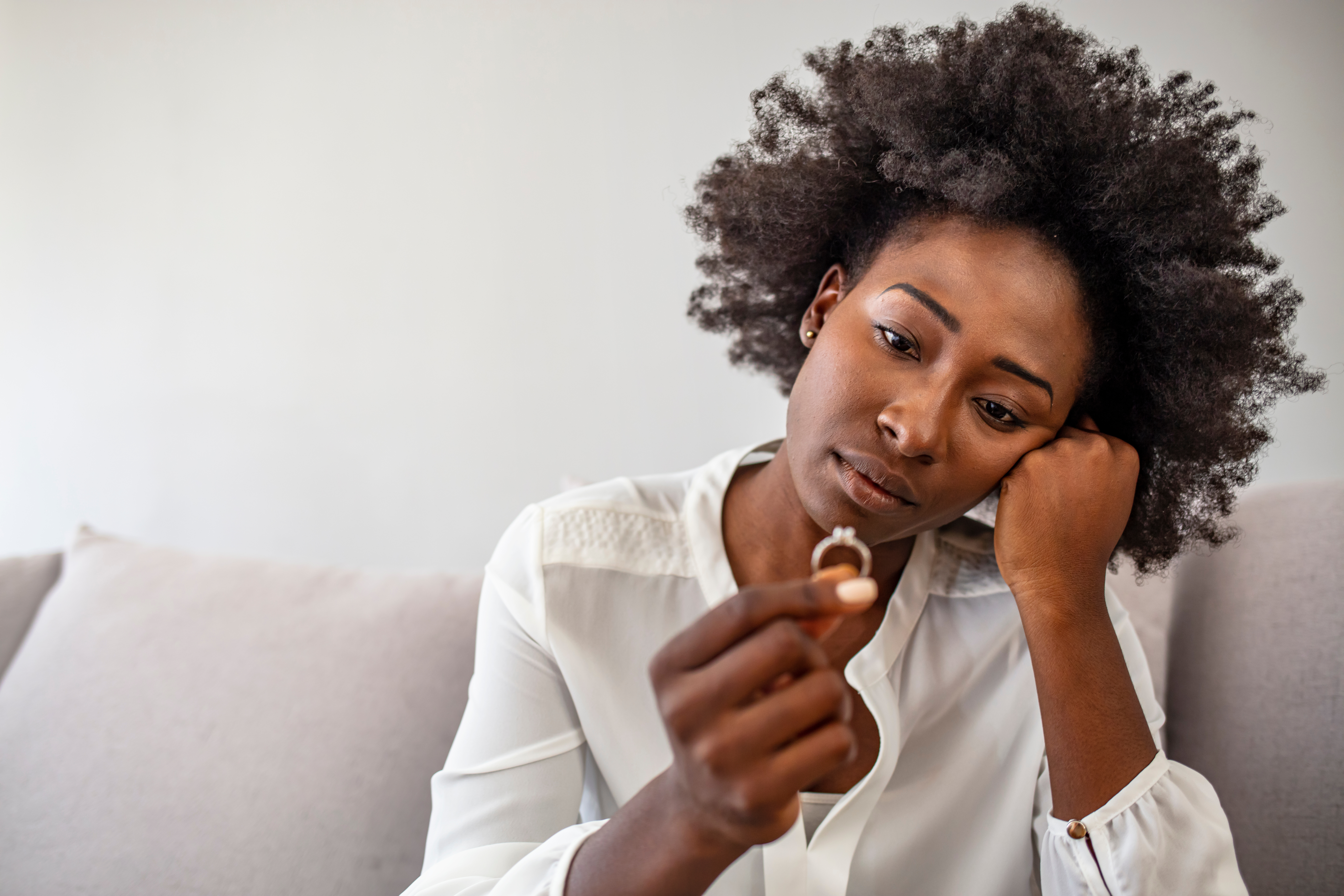 Unhappy woman holding wedding ring close up, upset girl crying, depressed with divorce, break up with boyfriend, broken engagement, feeling desperate, family split, bad relationships