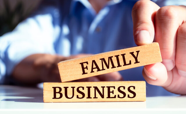 Closeup on businessman holding a wooden block with 